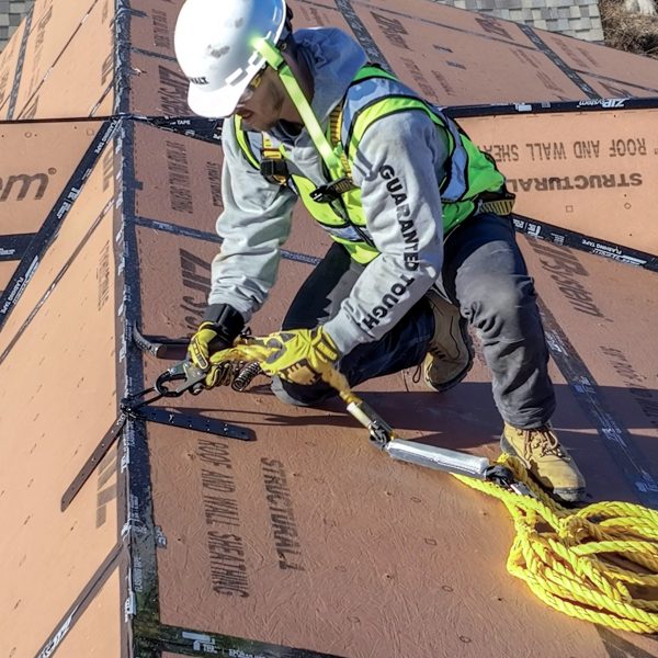 Worker using a tool on stacked building materials