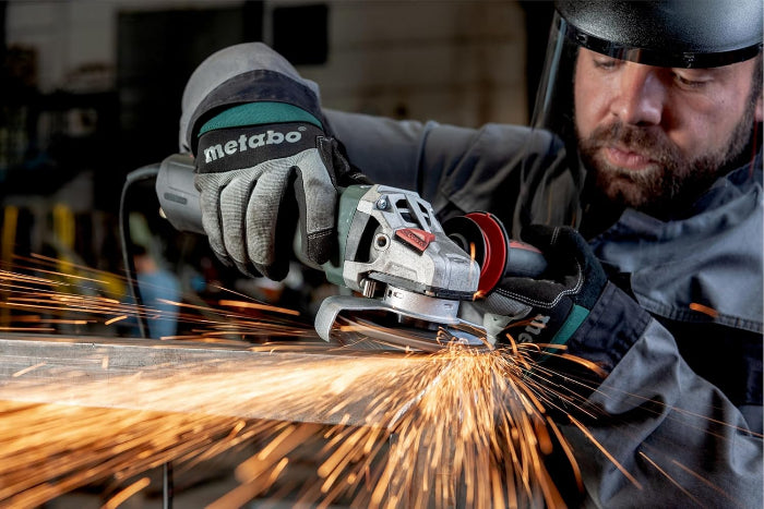 Person using a Metabo angle grinder with sparks flying