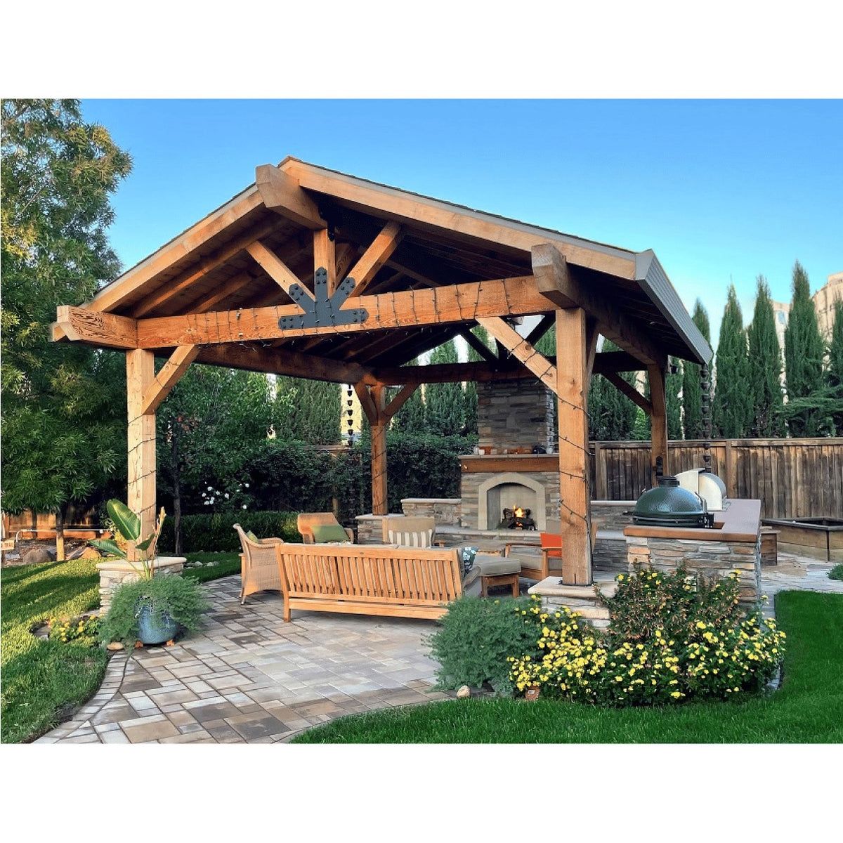Wooden pergola with outdoor furniture and fireplace in a garden setting