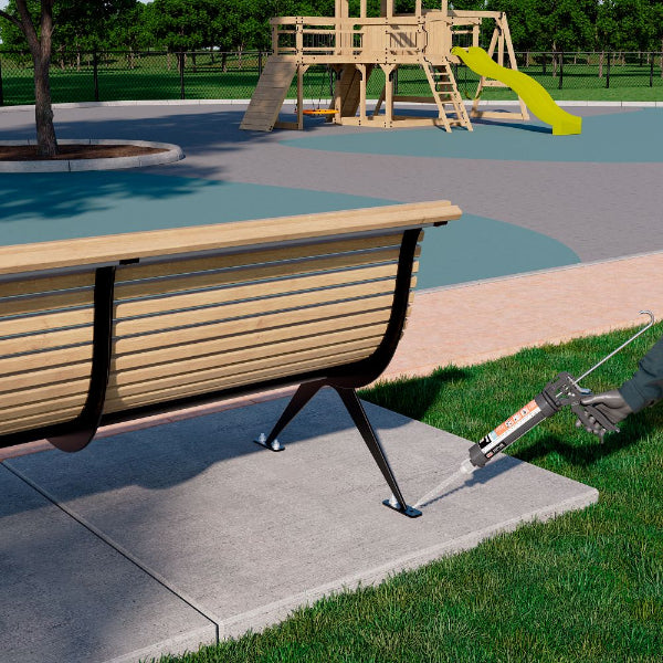 Person using a caulk gun on a wooden bench at a playground.