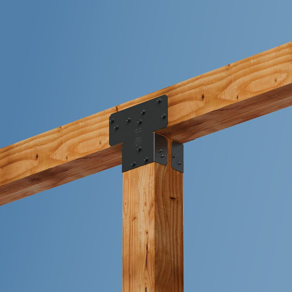 Wooden beams with metal brackets against a blue sky