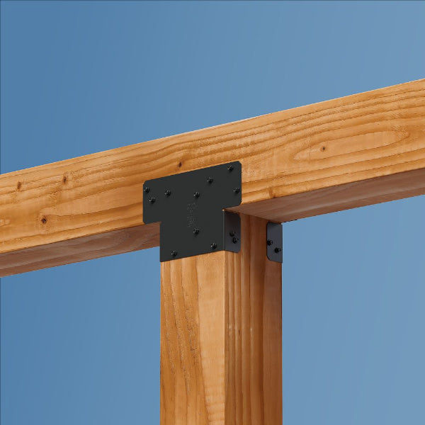 Wooden beams with a metal bracket against a blue sky