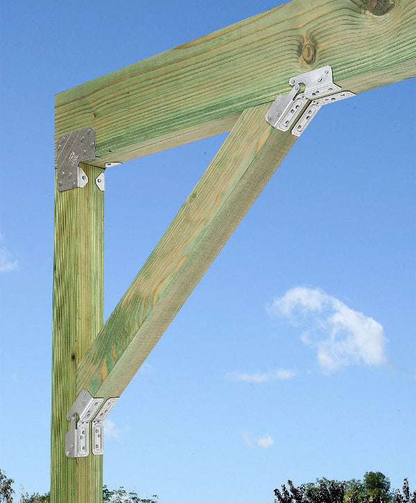 Wooden beam structure with brackets against a blue sky