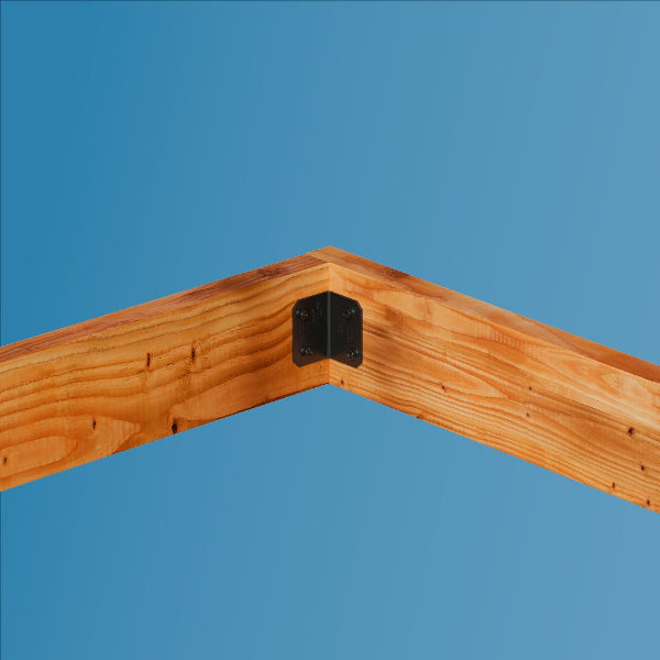 Wooden corner brace with a metal bracket against a clear blue sky
