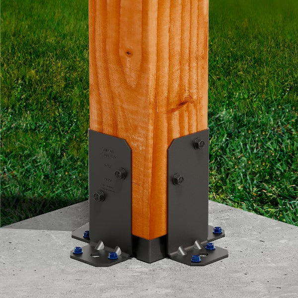 Wooden post with metal brackets on a concrete surface and grass background