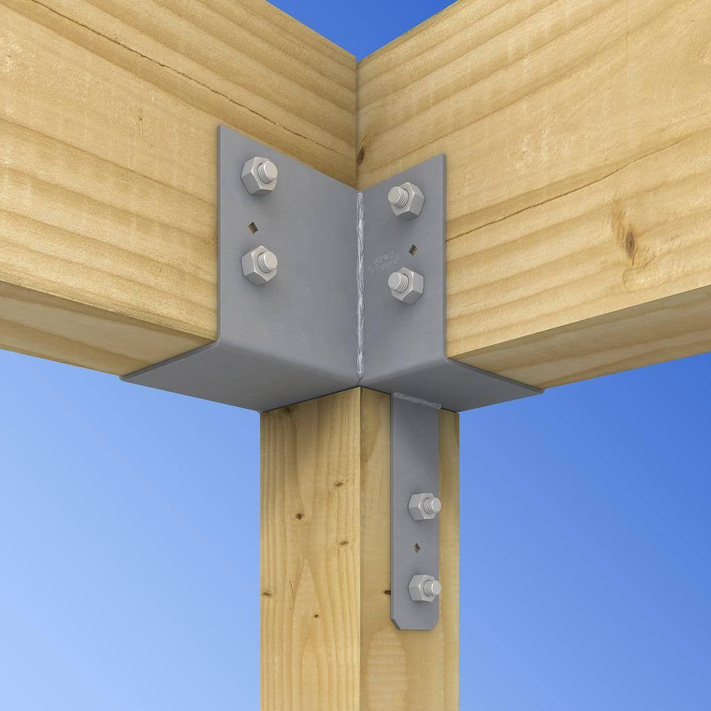 Gray metal L-bracket corner connector bolted to wooden beams and posts with silver hex bolts, shown against a blue sky background.