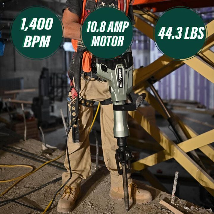 Person holding a power tool with specifications displayed on a construction site