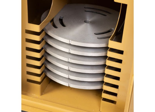 Stack of metal plates inside a gold-colored container with slotted design.