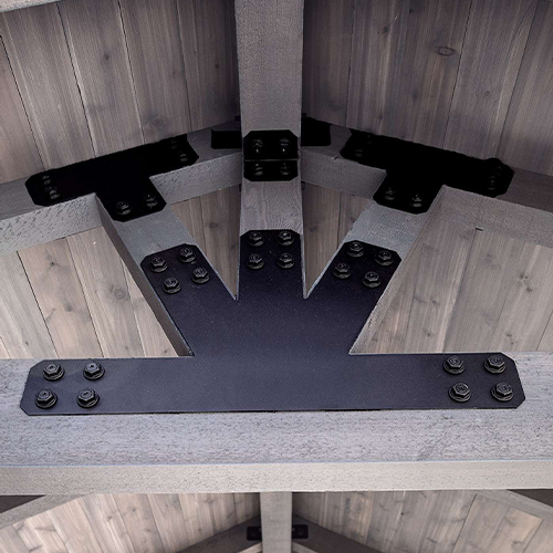 Metal bracket with screws on a wooden surface