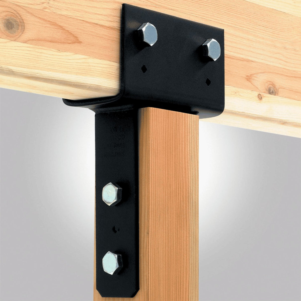 Wooden beam with a black metal bracket and screws on a gray background